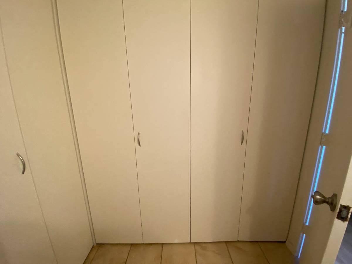 A white door with a silver handle is closed.